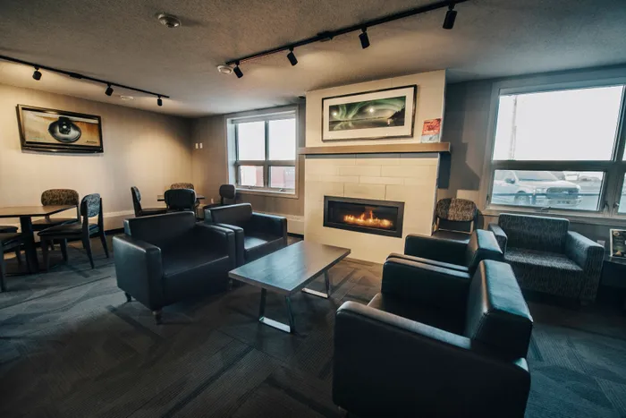 Inviting living area with cozy seating, modern fireplace, and ample natural light for a warm ambiance.