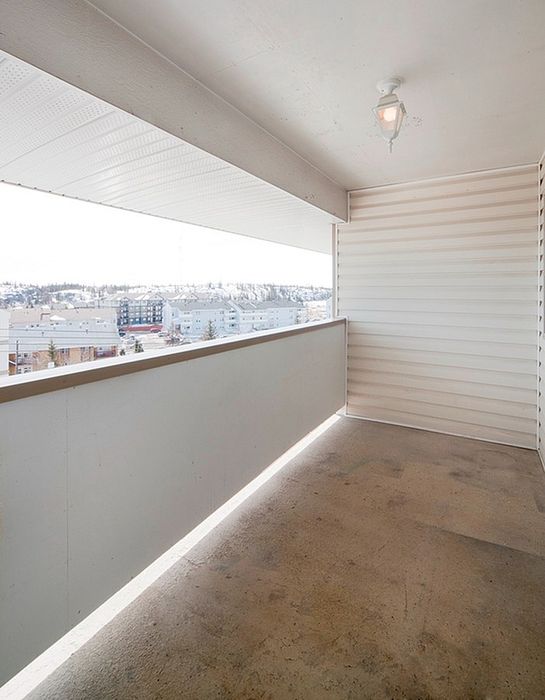 Bright and airy balcony with stunning cityscape views, perfect for relaxation and enjoyment in urban living.