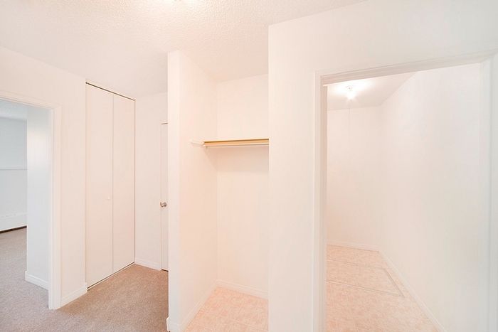 Bright and airy walk-in closet with modern design and ample storage space.