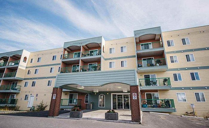 Charming multi-story apartment building showcasing modern balconies and a welcoming entrance.