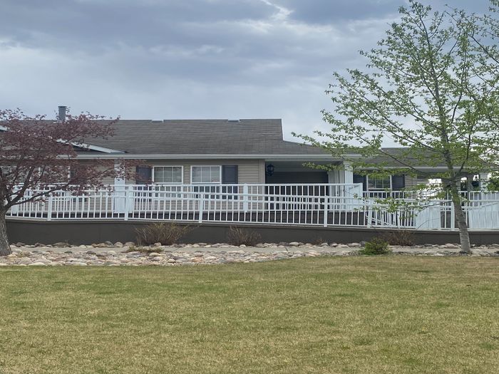 Charming single-story home with a welcoming front porch and well-maintained garden, perfect for peaceful living.
