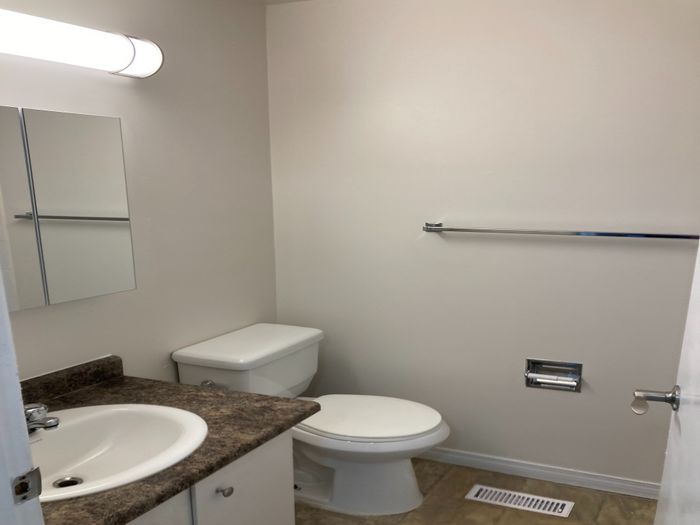 Chic, modern bathroom with sleek fixtures, elegant countertop, and soft ambient lighting.