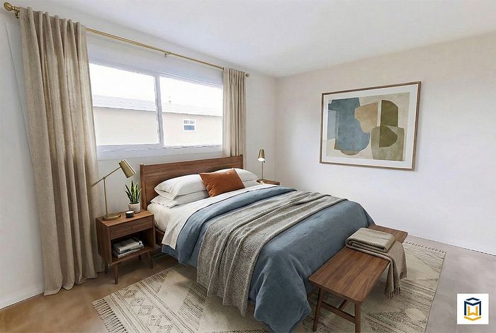 Cozy modern bedroom with a wooden bed frame, stylish artwork, and soft natural lighting, perfect for relaxation.