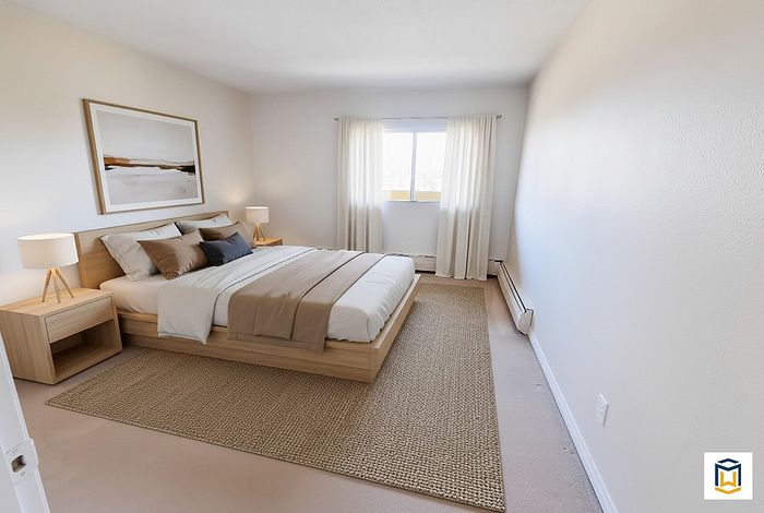 Bright, elegantly designed bedroom featuring a cozy bed with stylish pillows and wooden furnishings, complemented by soft natural light and tasteful decor.