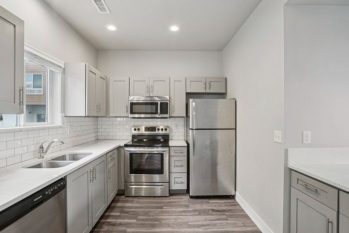 Charming residential building surrounded by lush greenery and vibrant autumn trees, featuring multiple balconies perfect for enjoying the scenic views.