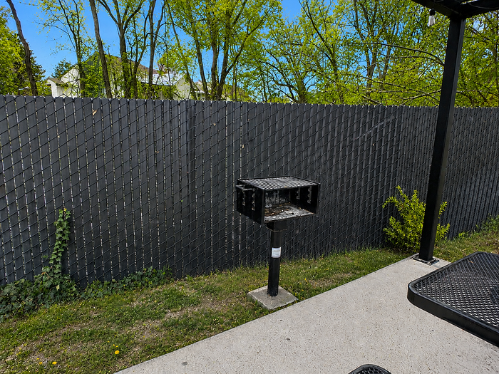 Charming residential building surrounded by lush greenery and vibrant autumn trees, featuring multiple balconies perfect for enjoying the scenic views.