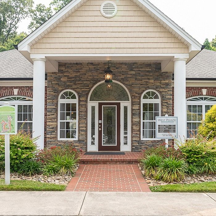 Elegant stone facade with symmetrical windows and welcoming entrance at West Pointe.