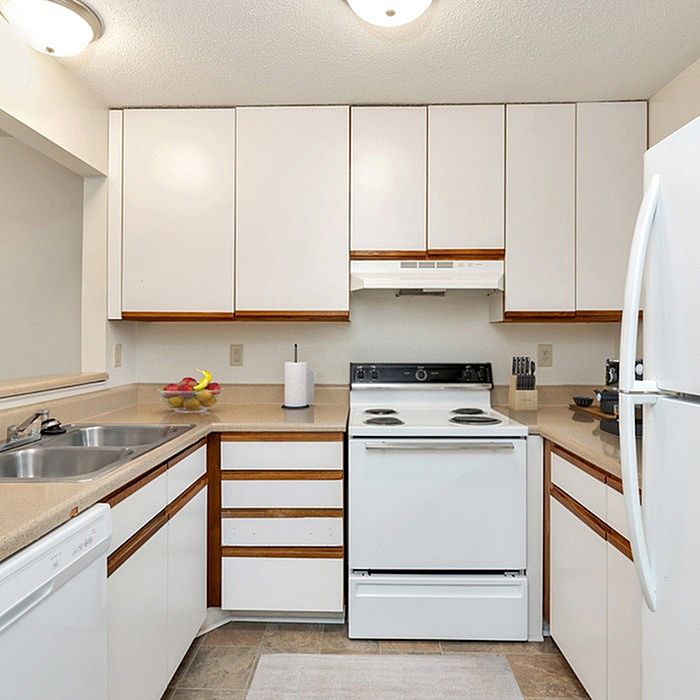 Bright and stylish kitchen with modern appliances, sleek white cabinetry, and spacious countertops.