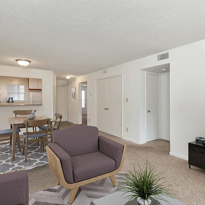 Modern open-plan living area featuring comfortable seating, a dining space, and a stylish kitchen.