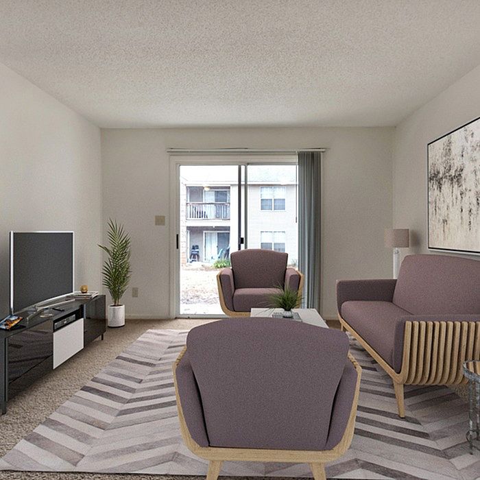 Inviting living room with modern furniture, a large window, and tasteful decor.