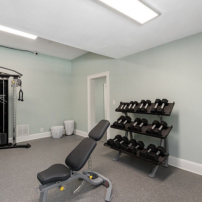 Contemporary home gym with modern equipment and sleek design.