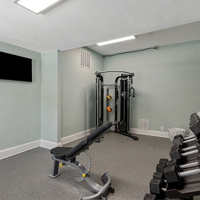 Sleek home gym with modern fitness equipment and a soothing atmosphere.