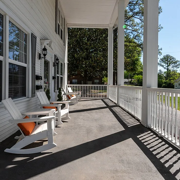 Large leasing center with porch and comfortable chairs.