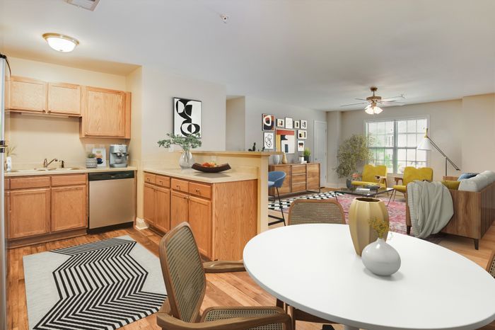 Stylish open-concept apartment with modern kitchen, dining area, and bright living space.