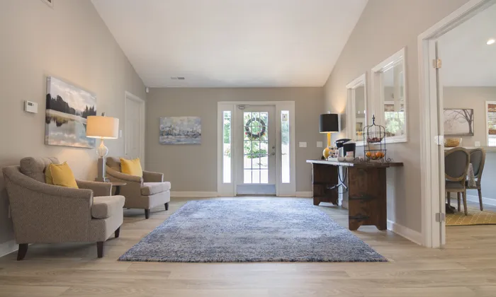 Inviting living area with a cozy sitting space, stylish decor, and abundant natural light.