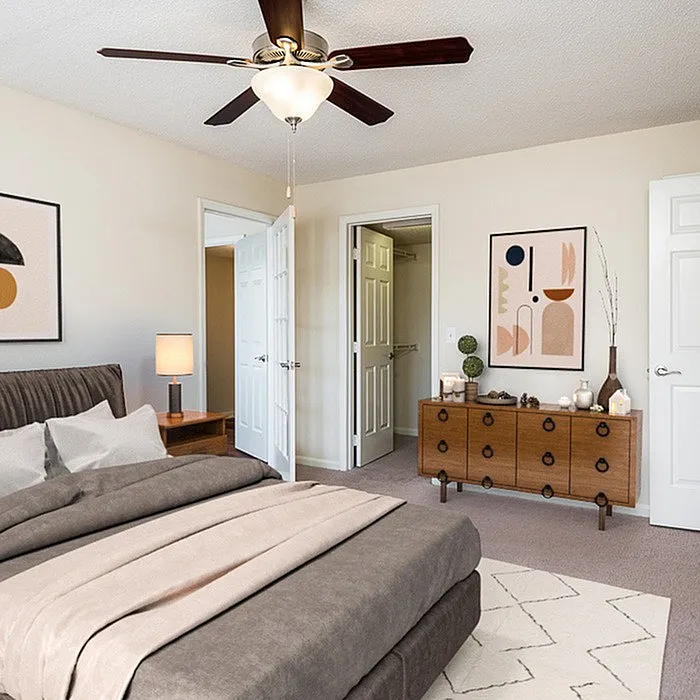 Elegant bedroom featuring a cozy bed, modern artwork, and stylish furniture with a spacious walk-in closet.