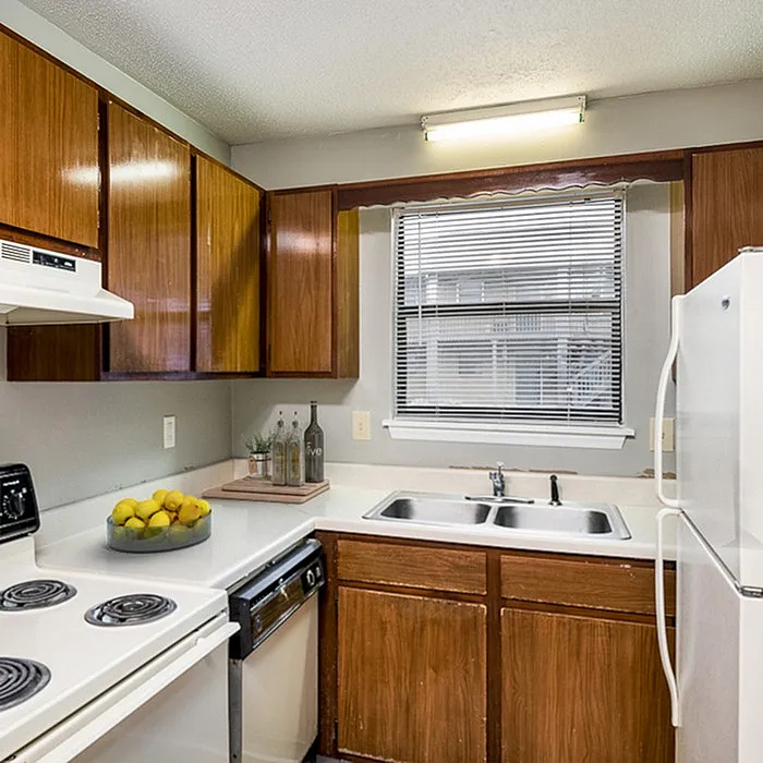 Charming kitchen with elegant dark wood cabinets, modern appliances, and a cozy, bright ambiance.