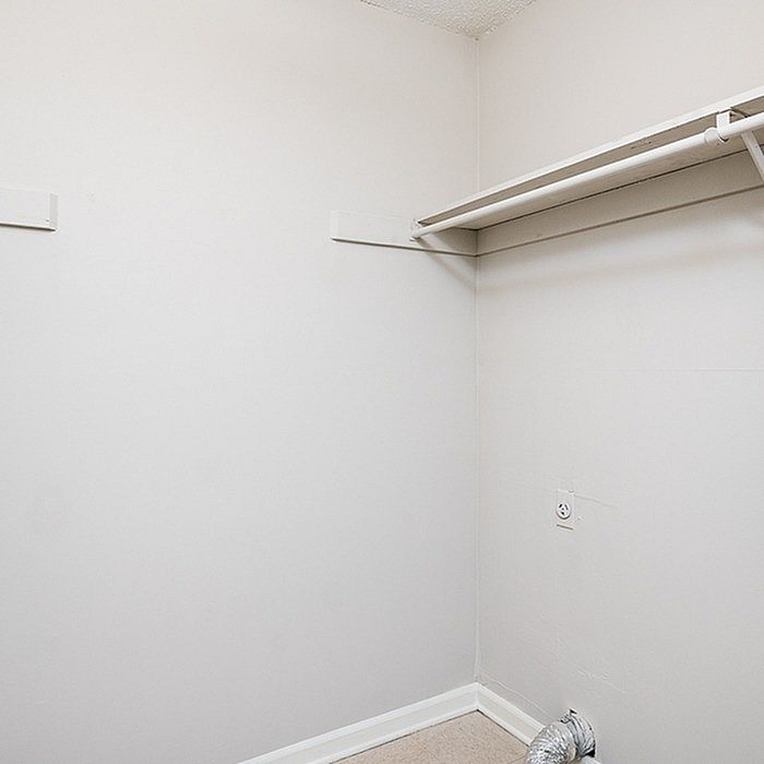 Bright and spacious closet area with ample shelving, perfect for organized storage.