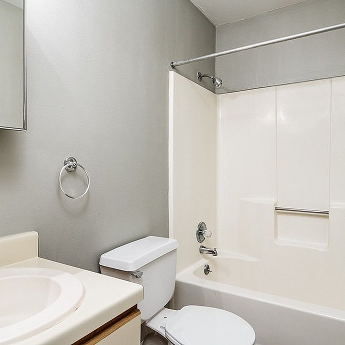 Sleek and modern bathroom featuring a pristine bathtub, elegant fixtures, and calming neutral tones.