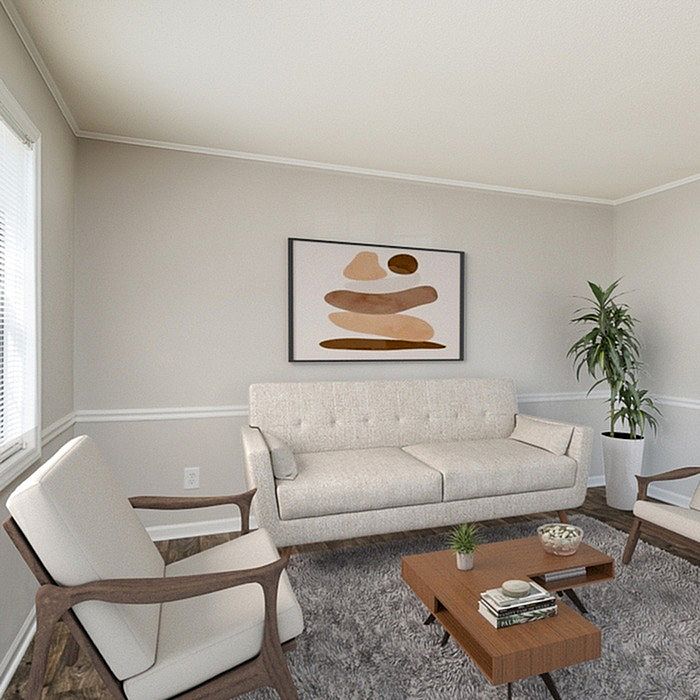 Modern living room with elegant beige sofa, stylish armchairs, and chic decor, perfect for relaxed comfort.