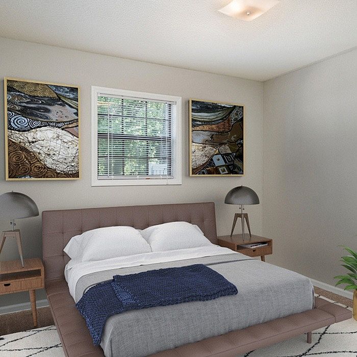 Elegant bedroom with modern decor, featuring a comfortable bed, chic lamps, and exquisite artwork, promising relaxation and style.