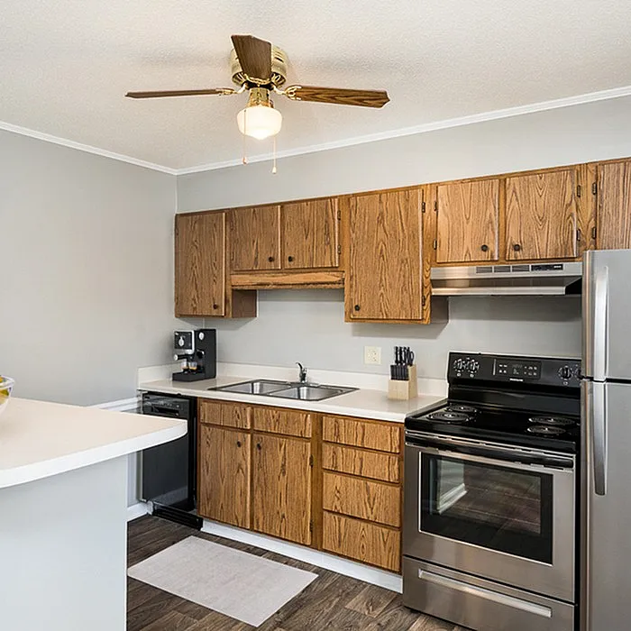 Charming modern kitchen featuring sleek stainless steel appliances, elegant wooden cabinetry, and a cozy breakfast bar.