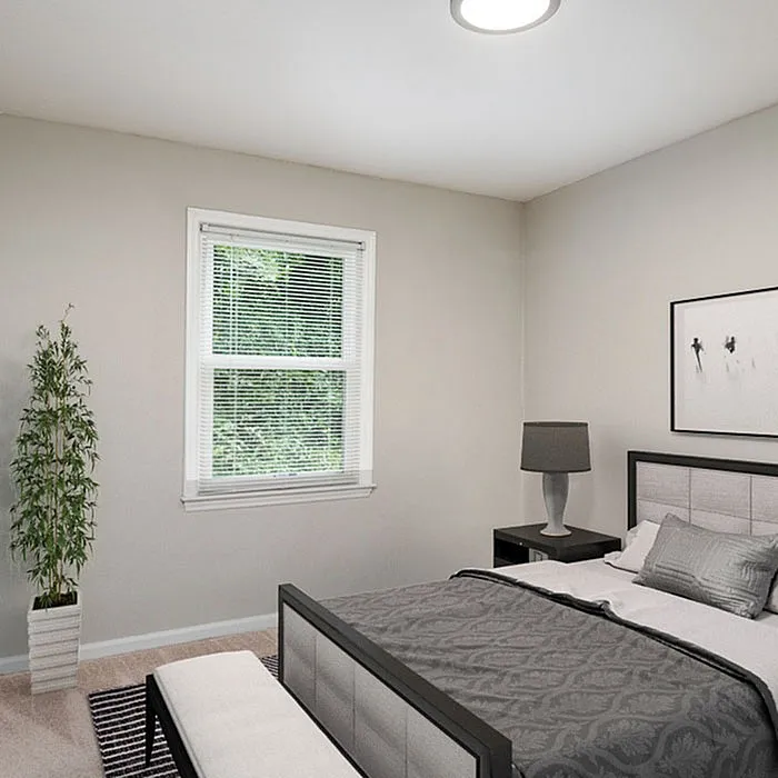 Inviting bedroom with modern furniture, elegant decor, and a sunlit window offering soothing natural views.