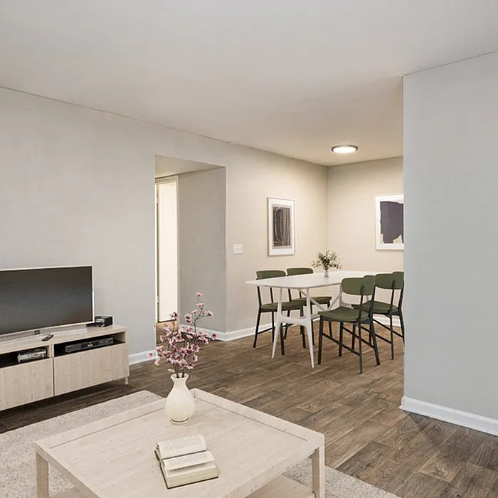 Modern open living space with a cozy dining area, stylish furniture, and elegant wood flooring, perfect for comfortable living.