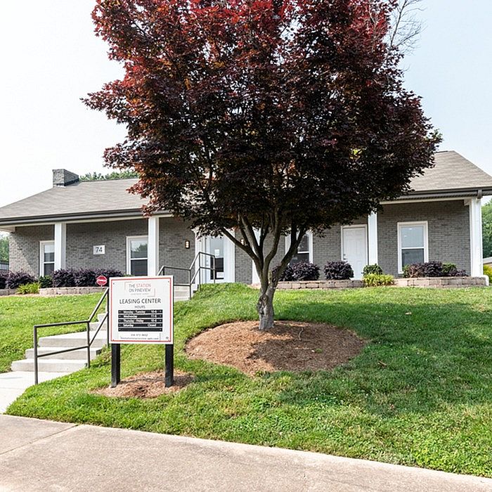 Inviting leasing center with charming landscaping and modern brick exterior, perfect for welcoming new tenants.