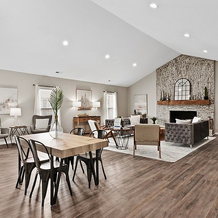 Elegant open-concept living and dining area with stylish decor, cozy fireplace, and modern furnishings, perfect for entertaining.