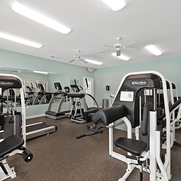 Modern fitness center with state-of-the-art exercise equipment and sleek interior design.