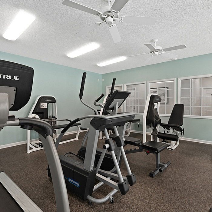 Modern fitness center with state-of-the-art equipment, including treadmills and weight machines, in a bright and welcoming space.