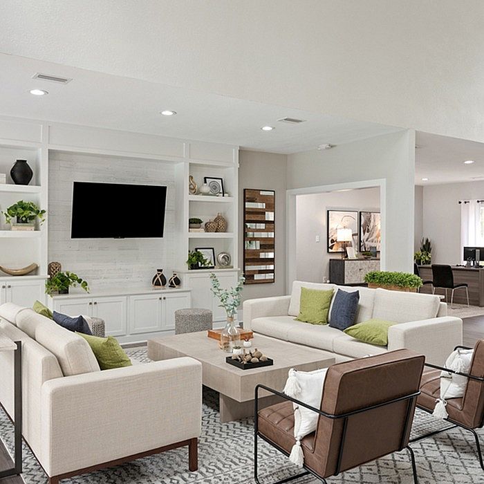 Elegant living room with modern seating, stylish decor, and a sleek entertainment center, exuding comfort and sophistication.