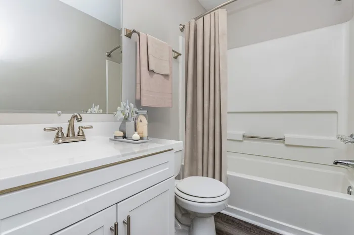 Elegant bathroom with white cabinets and countertops.