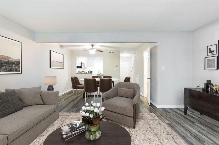 Modern open-plan living area with high ceilings, sleek kitchen, and cozy seating.