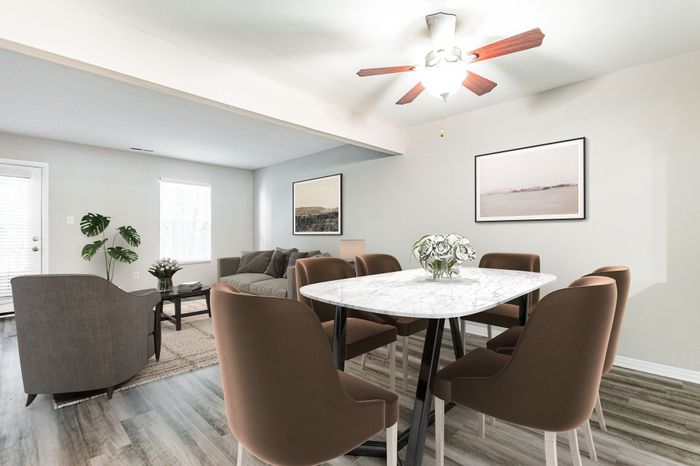 Modern open-plan living area with high ceilings, sleek kitchen, and cozy seating.