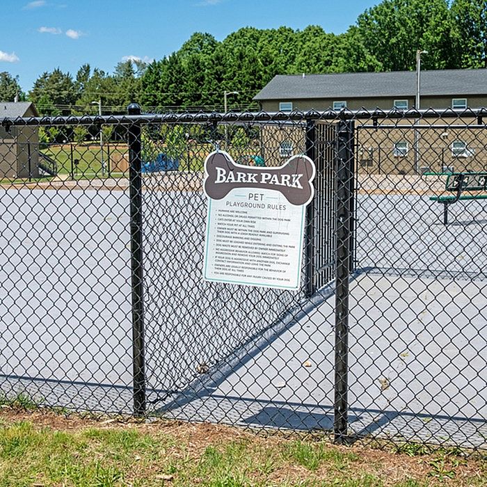 Inviting Bark Park with open space, perfect for playful dogs in a serene community setting.