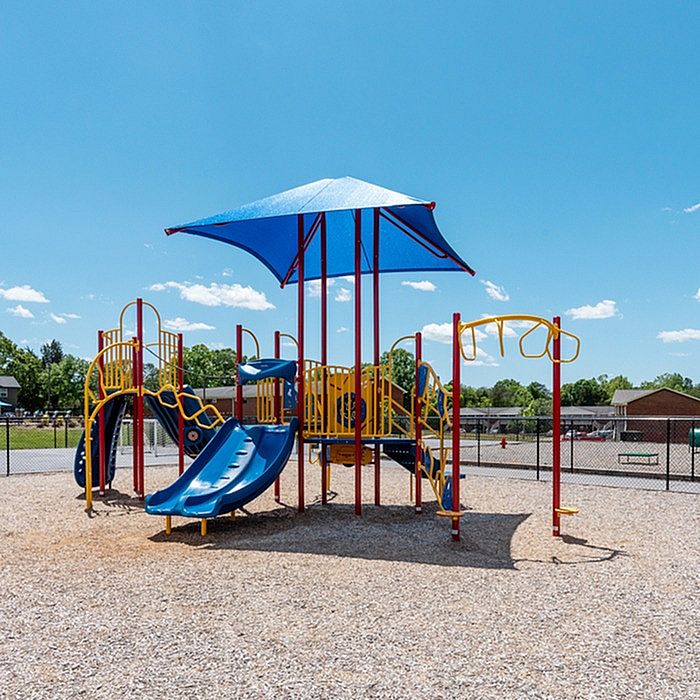 Vibrant playground with colorful slides and climbing structures, perfect for children to enjoy sunny days.