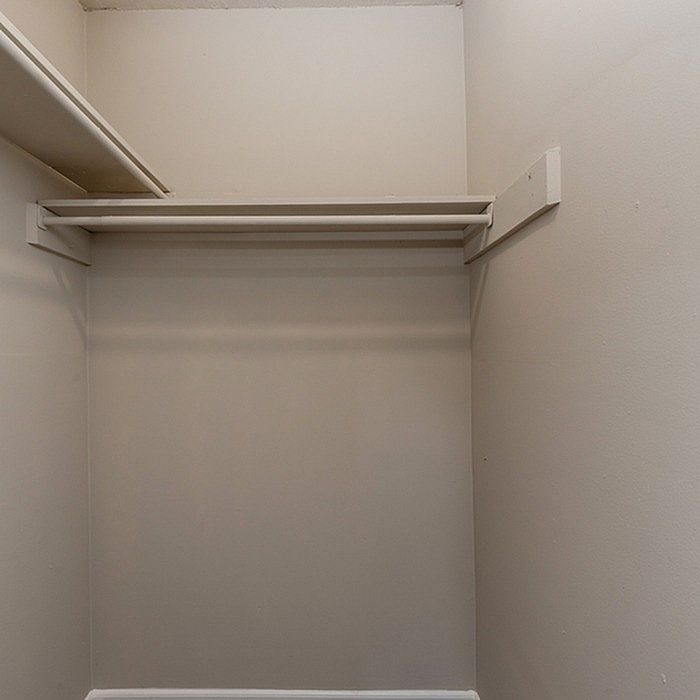 Spacious walk-in closet with ample shelving and hanging space, perfect for organizing your wardrobe.