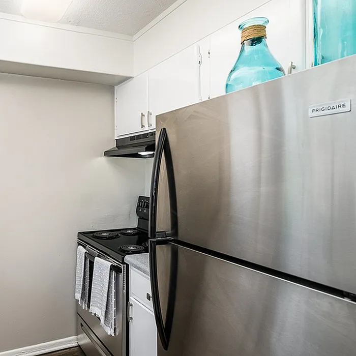 Modern kitchen with sleek stainless steel appliances, stylish white cabinetry, and elegant decor accents.