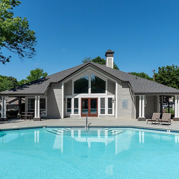 Inviting clubhouse with modern architecture and a sparkling pool, perfect for relaxation and social gatherings.