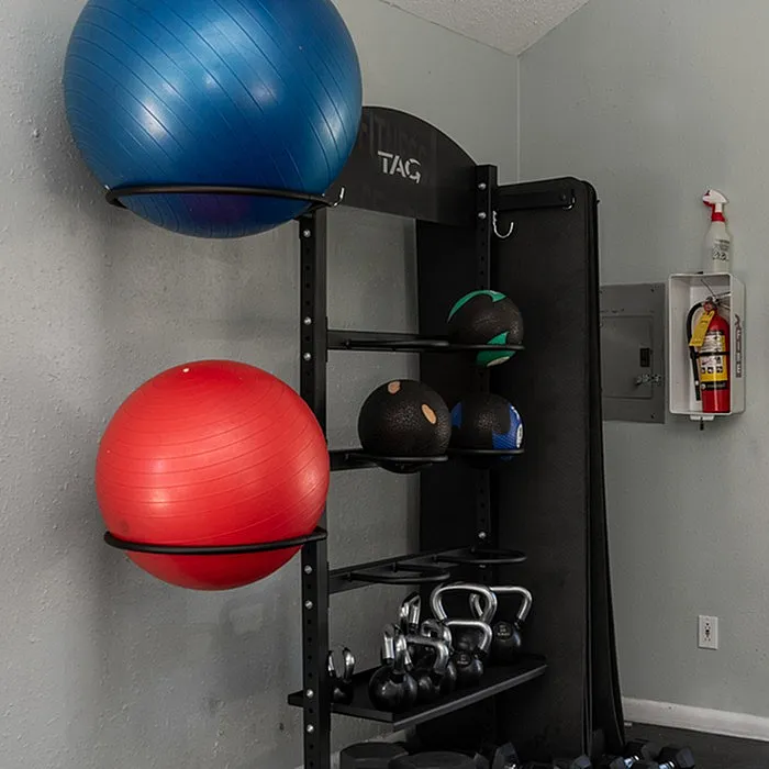 Inviting home gym corner with vibrant exercise balls, kettlebells, and medicine balls neatly organized, offering a dynamic workout space.