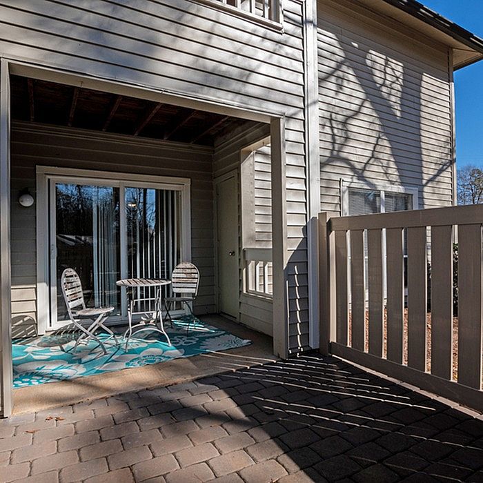 Charming outdoor patio with stylish furniture and private fencing, perfect for relaxation and outdoor entertaining.