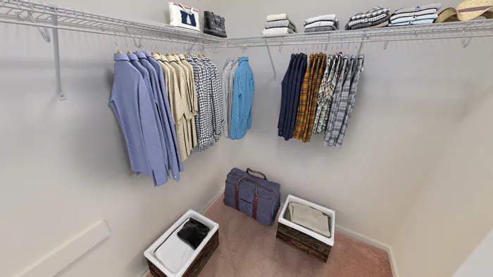 Spacious and organized walk-in closet with ample hanging space, neatly arranged clothes, and convenient storage baskets, perfect for stylish living.