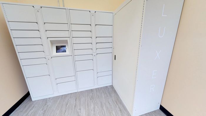 State-of-the-art package locker station with sleek white design, offering secure and convenient parcel storage.