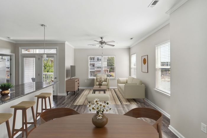Charming open-concept living area with a modern kitchen, sleek granite countertops, and inviting seating perfect for entertaining.