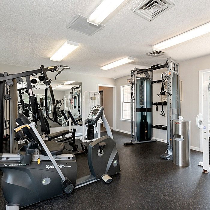 Bright and modern fitness center featuring state-of-the-art exercise equipment, perfect for a comprehensive workout experience.