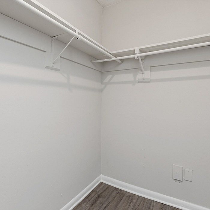 Expansive walk-in closet with ample shelving and modern design, perfect for organized living.