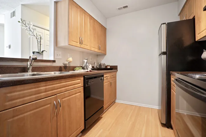 Contemporary kitchen with sleek stainless steel appliances, elegant wood cabinetry, and stylish countertops for modern living.