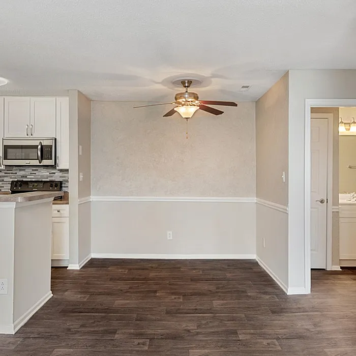 Charming open-concept kitchen and dining area with sleek flooring, modern appliances, and elegant lighting, perfect for cozy gatherings.